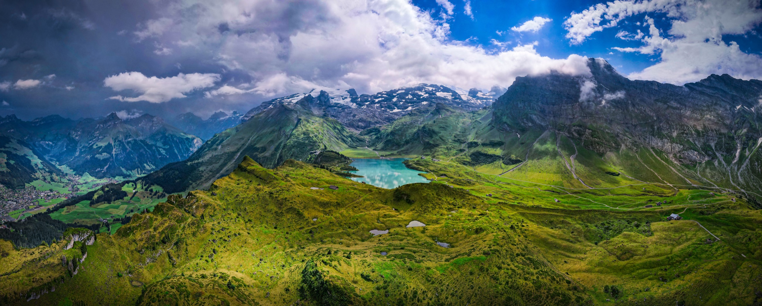 Alpine valley and peaks at sunset, aerial panorama
